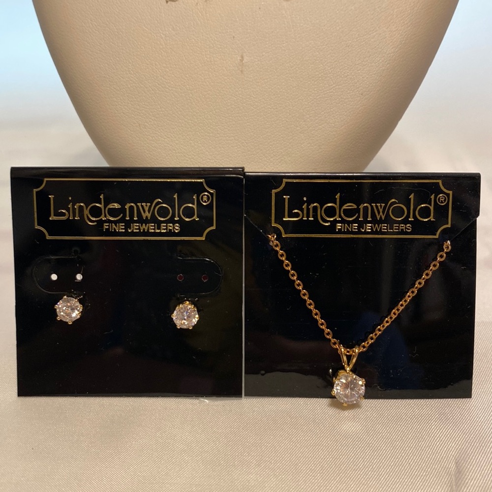 The 17 1/5” gold tone necklace & pierced earrings have zirconium stones.